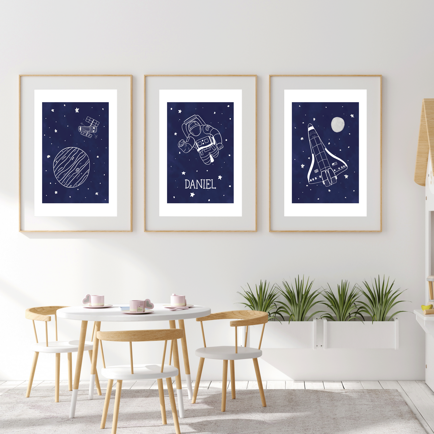 Set of 3 space designs, astronaut, rocket and planet in white set onto a night sky blue background with stars